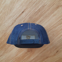 Load image into Gallery viewer, Plastic clip at back of high quality Full denim truckers cap with gold SJS &quot;planer&quot; logo on front panel
